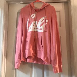 Pink and white zip up hoodie.